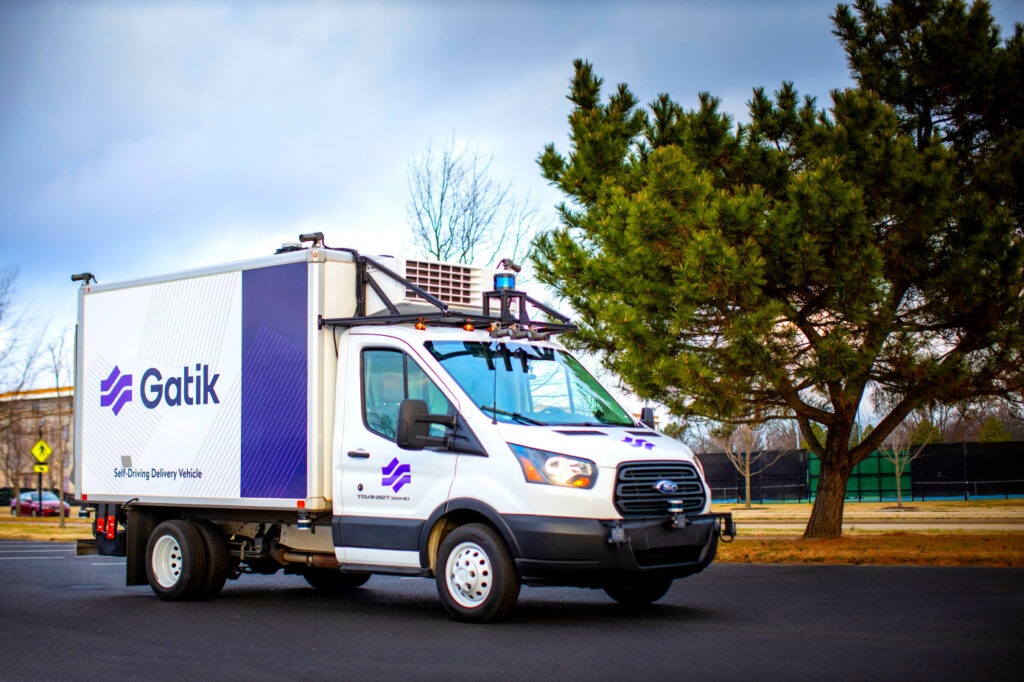 Gatik, a self-driving delivery truck, driving through a parking lot