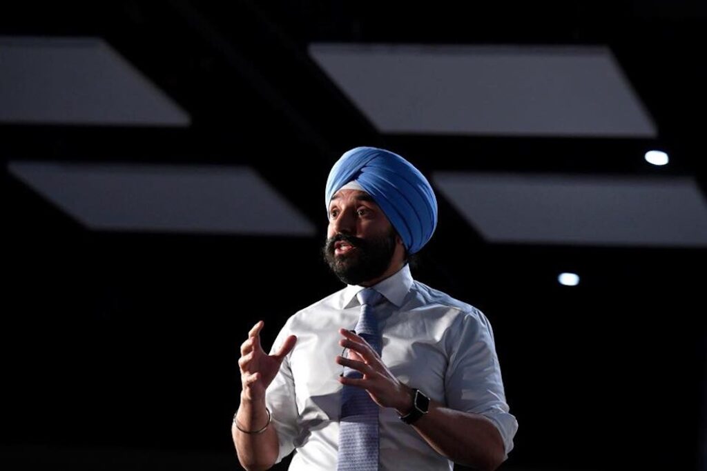 Navdeep Bains, former Minister of Innovation, Science and Industry of Canada public speaking at an event.