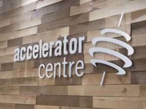 Accelerator Centre sign on a wood paneled wall