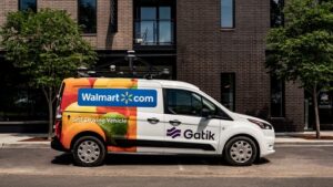 A self-driving delivery vehicle by Gatik outside of an apartment building