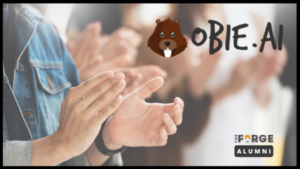 Promotional material for Obie.AI, alumni from The Forge, showing an individual clapping in a crowd