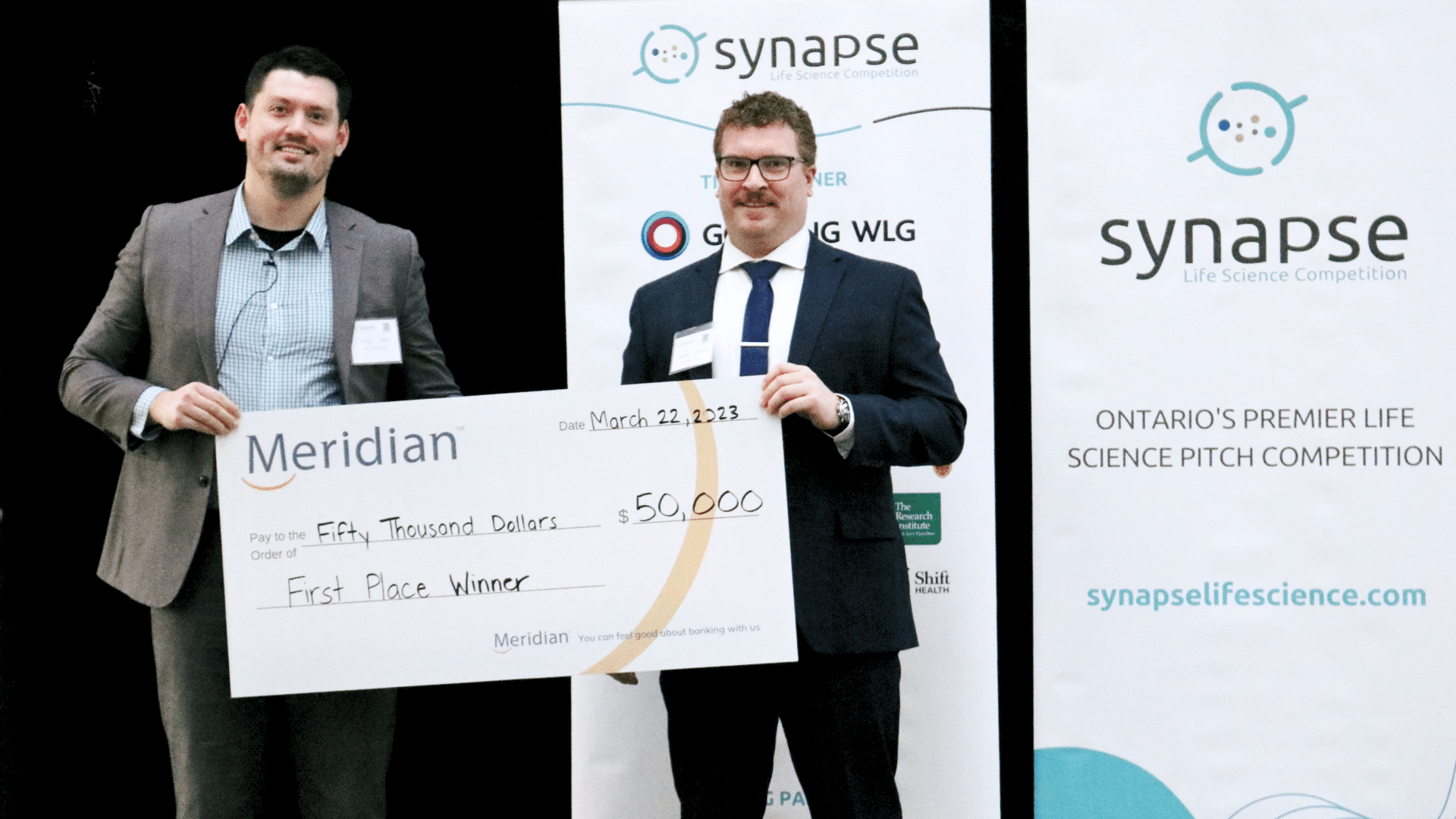 2023 Synapse Competition winner Vessl Prosthetics COO and Co-founder Oleksiy Zaika accepts check from competition judge Gowling WLG's Derek Sheppard