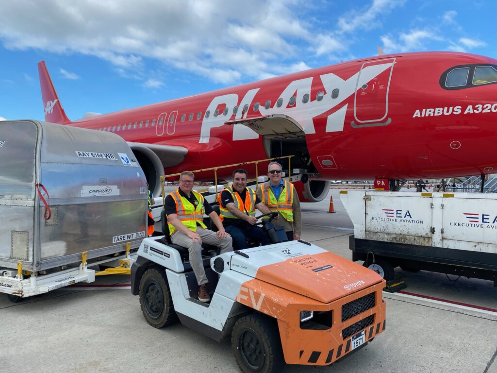 Kai Fahrbach,General Manager Business Development, Toyota Tsusho Canada Inc., Dr. Ali Emadi, CEO, Enedym, Grant Town, General Manager, Toyota Tsusho Canada Inc. at the Hamilton International Airport with the Enedym luggage hauler. 